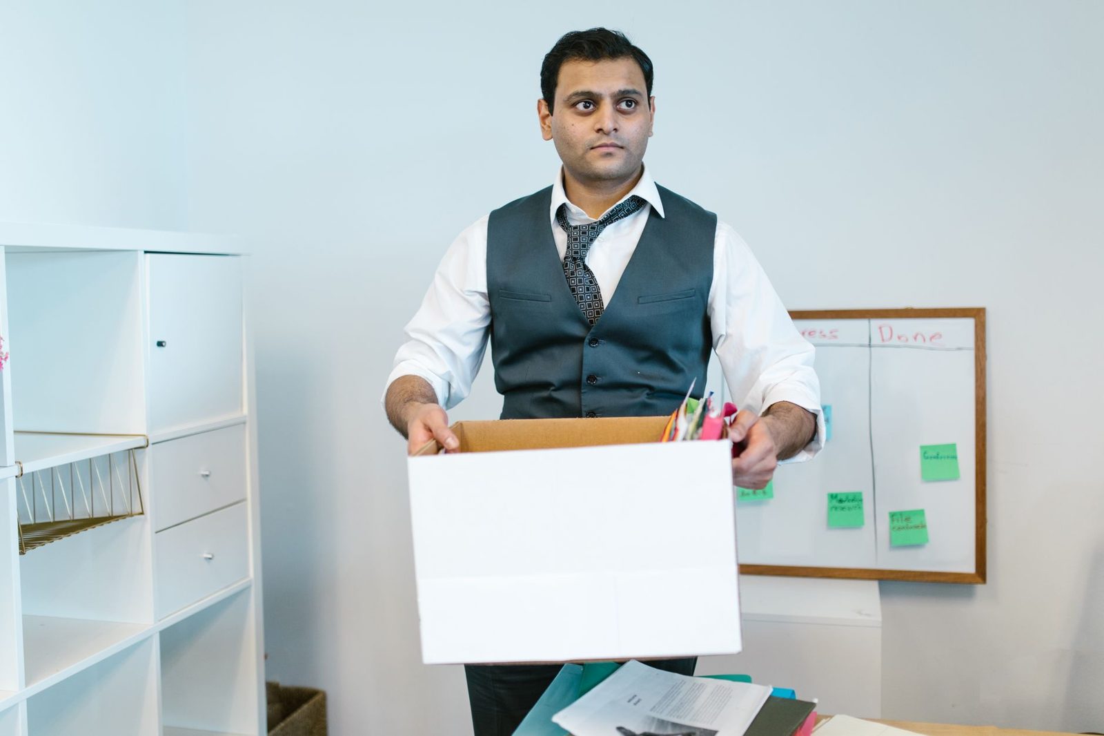 Office worker carrying a box of belongings