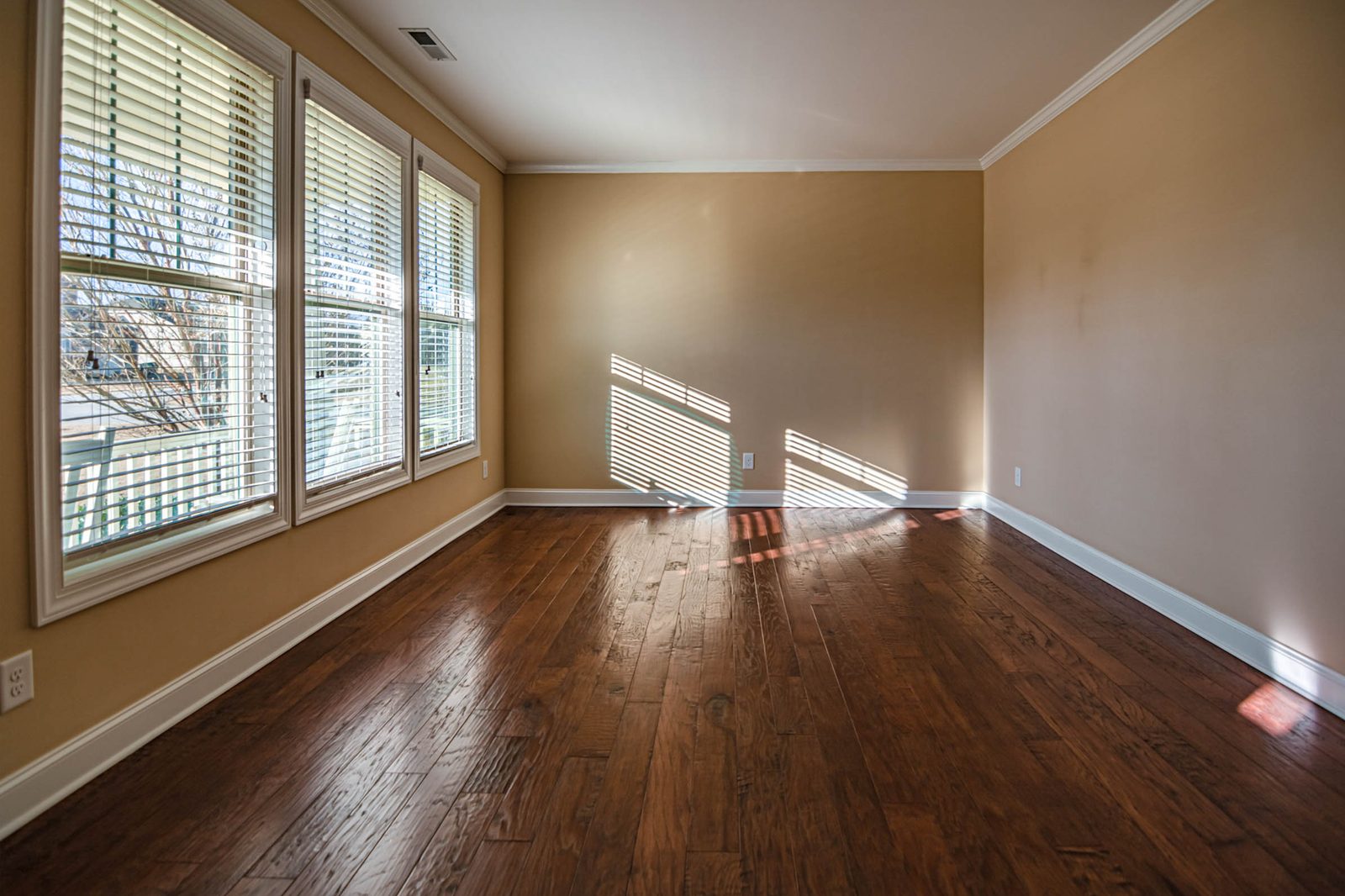 Empty, sunlit room after a clearance